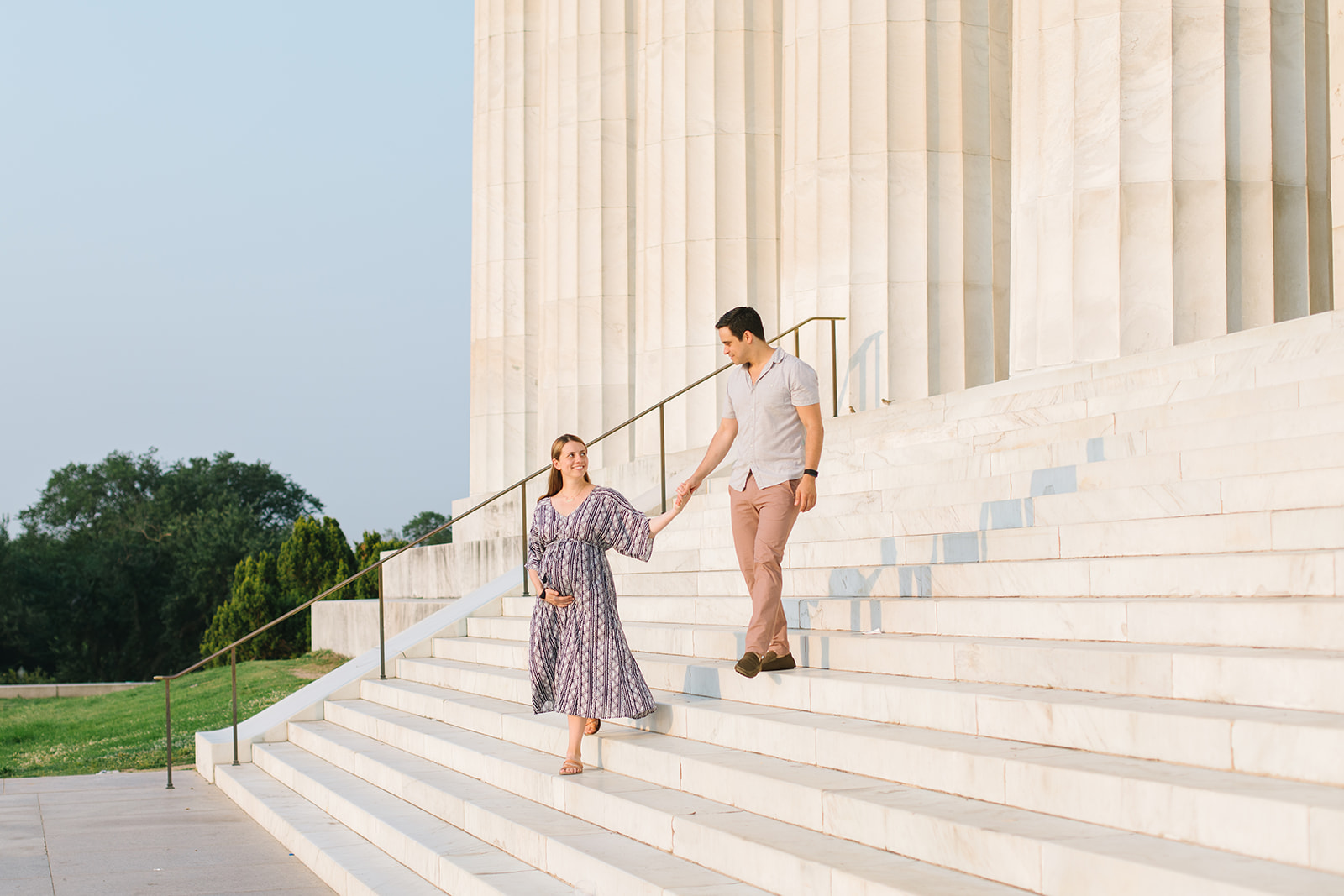 mom-to-be and partner walking down stairs during their Babymoon Near DC