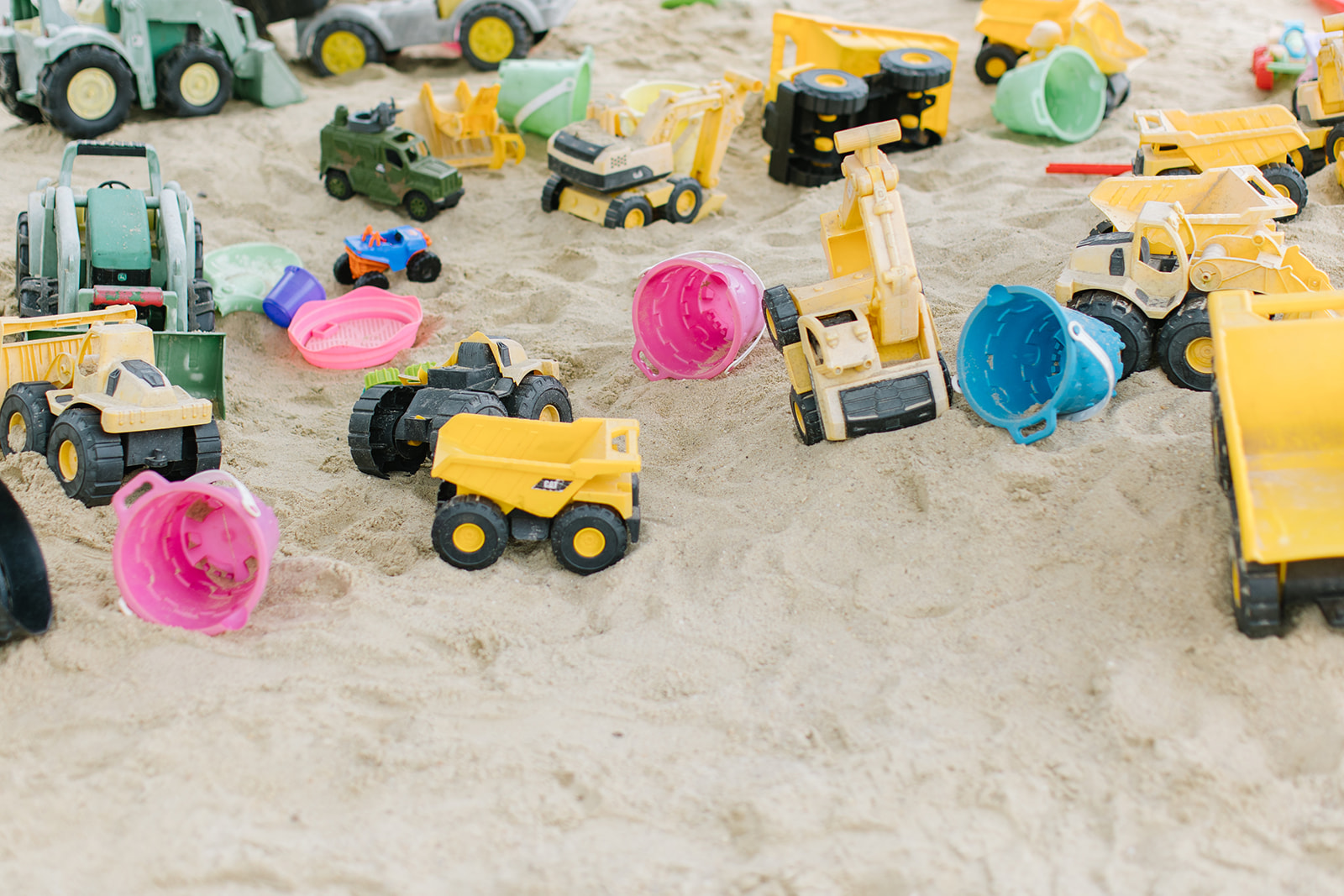 toy trucks in a sand box