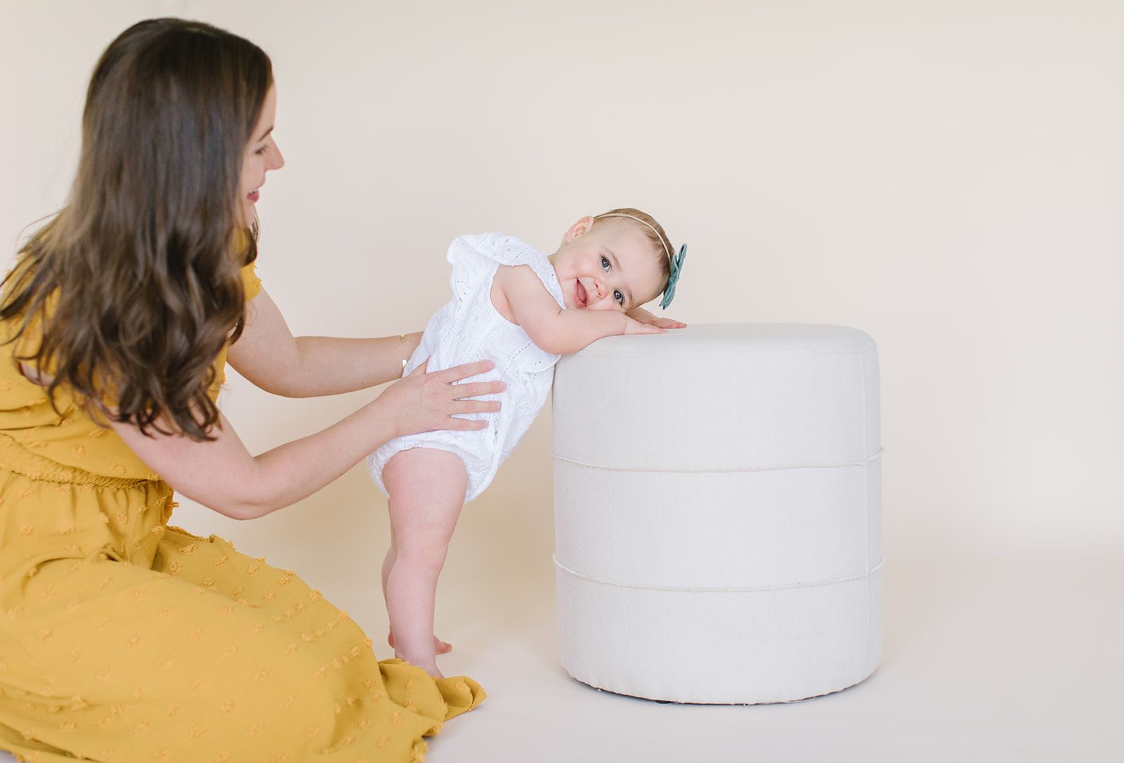 mom helping her daughter stand in a studio Washington DC Baby Photographer
